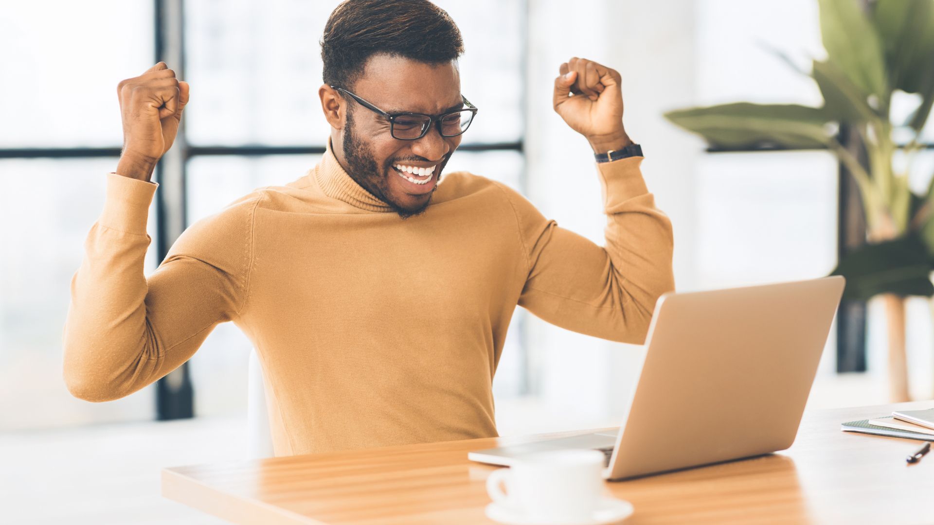 man with hands in air with celebration